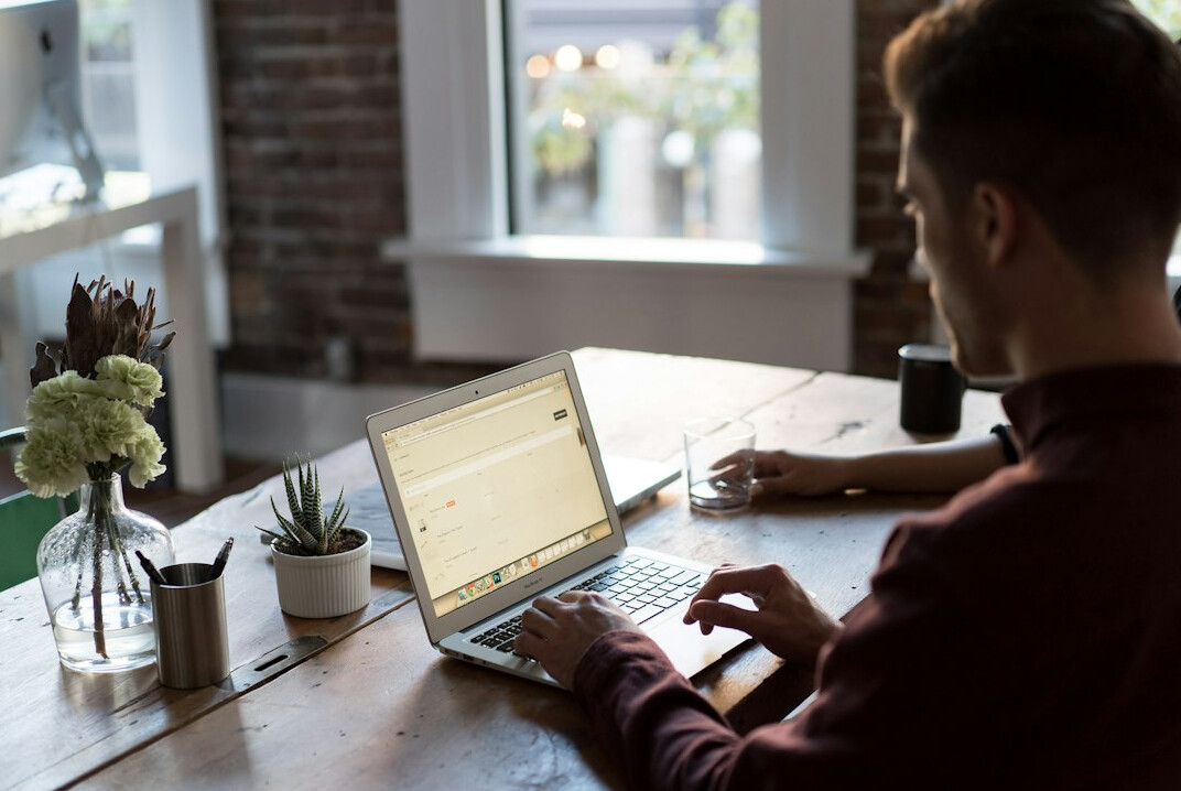 person working remotely on laptop